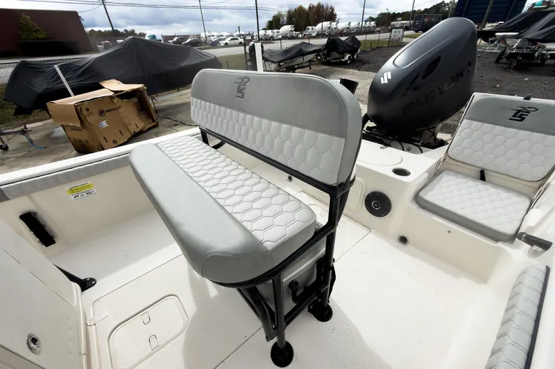 Slide: The Image of 2026 Carolina Skiff 21 LS boat interior with seating and motor, displayed outdoors. - 11