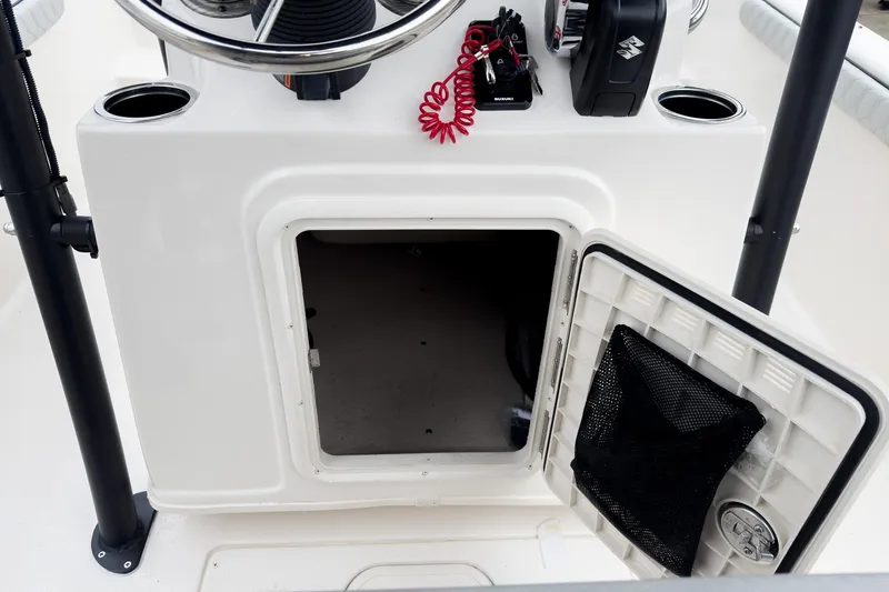 Slide: The Image of Open storage compartment on 2026 Carolina Skiff 21 LS boat console. - 16