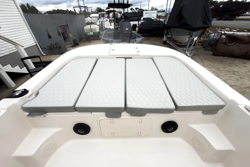 Slide: The Image of 2026 Carolina Skiff 21 LS boat interior with cushioned seating and storage compartments. - 24