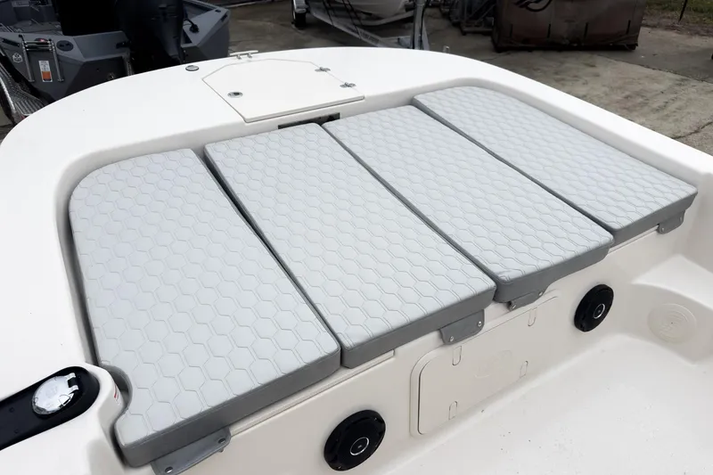 Slide: The Image of 2026 Carolina Skiff 21 LS boat with cushioned seating and storage compartment. - 25