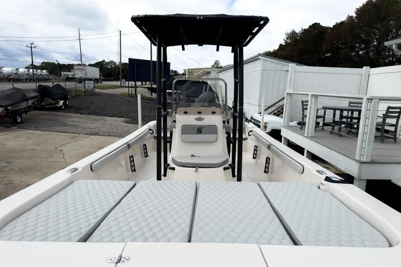 Slide: The Image of 2026 Carolina Skiff 21 LS boat with T-top and cushioned seating, docked outdoors. - 29