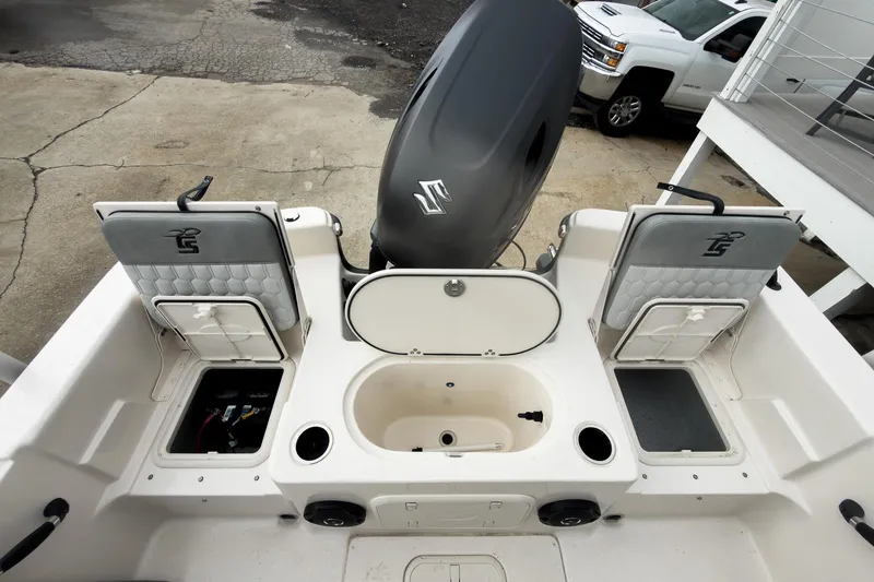 Slide: The Image of 2026 Carolina Skiff 21 LS boat interior with storage compartments and motor. - 7