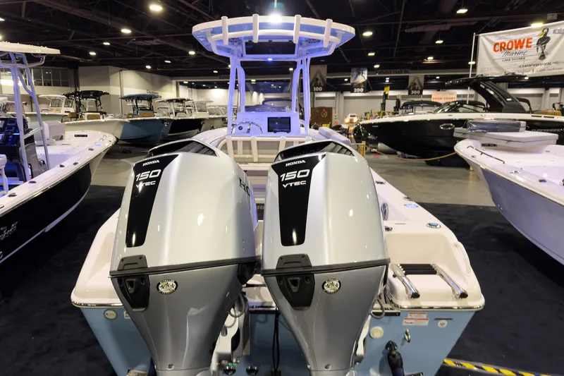 Slide: The Image of 2026 Sea Chaser 24 HFC DE boat with dual Honda 150 VTEC engines at a boat show. - 3