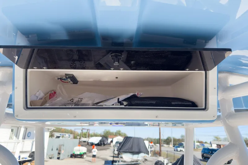 Slide: The Image of Open storage compartment on 2026 Sea Chaser 24 HFC DE boat, containing miscellaneous items. - 31
