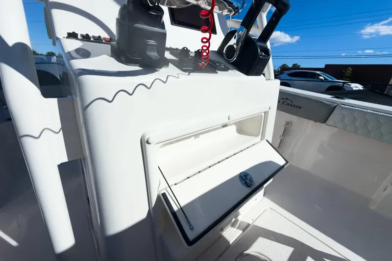 Slide: The Image of 2026 Sea Chaser 24 HFC DE boat console with storage compartment and controls. - 35