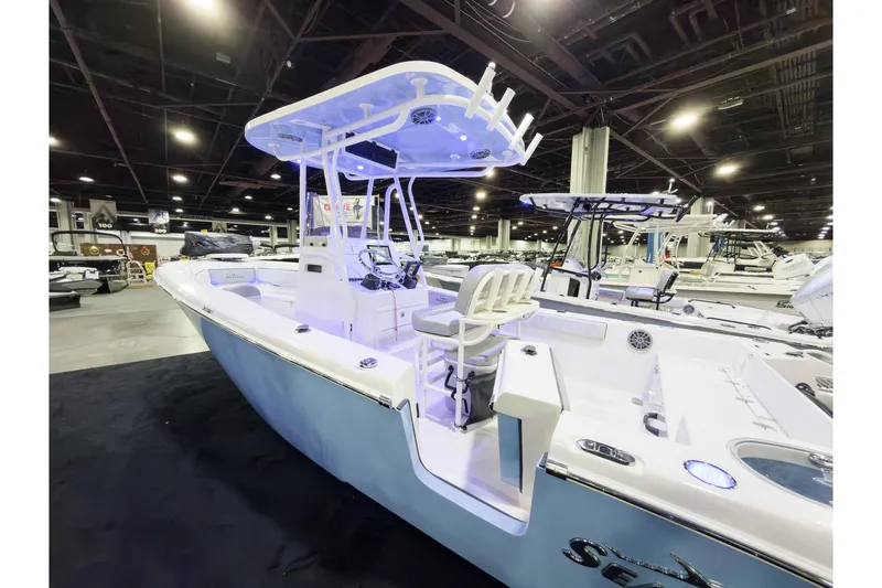 Slide: The Image of 2026 Sea Chaser 24 HFC DE boat displayed at an indoor exhibition. - 4