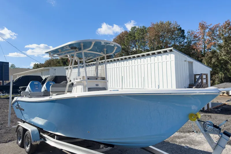 Slide: The Image of 2026 Sea Chaser 24 HFC DE boat on trailer, blue hull, parked outdoors. - 40