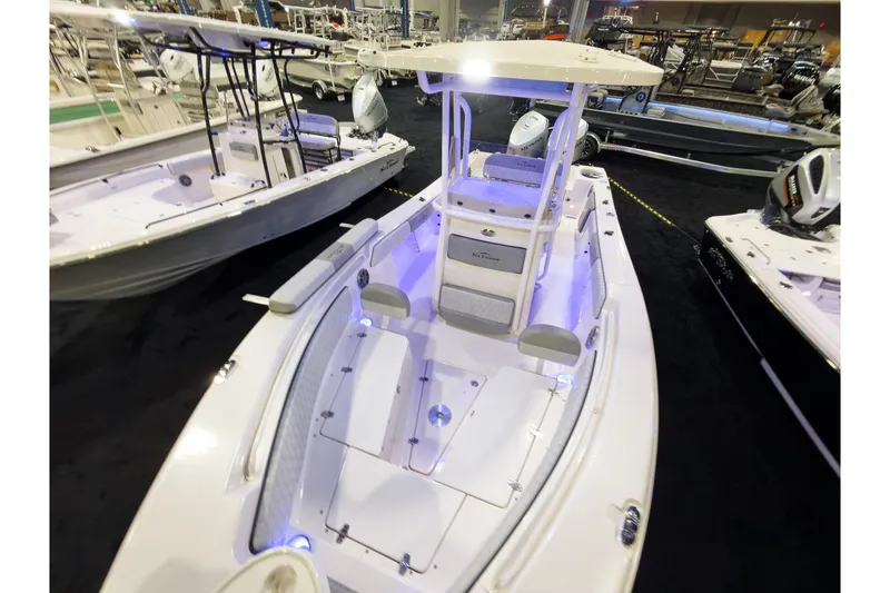 Slide: The Image of 2026 Sea Chaser 24 HFC DE boat displayed at a boat show, featuring modern design. - 5