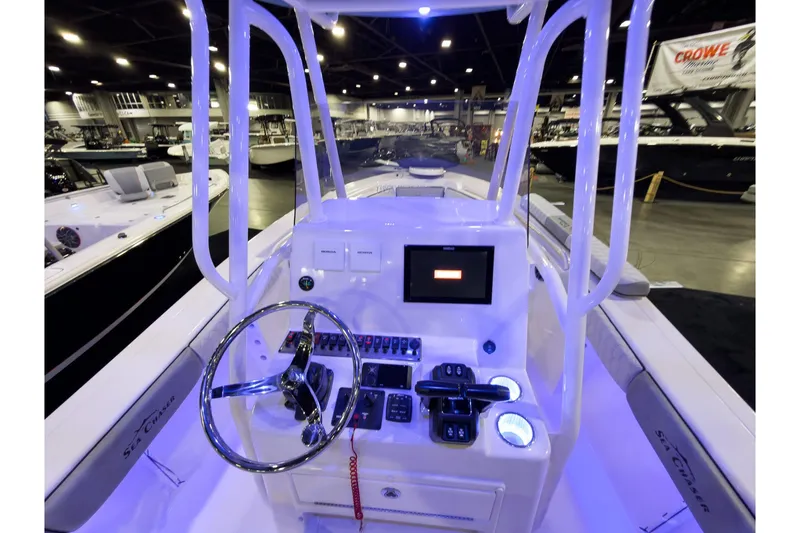 Slide: The Image of 2026 Sea Chaser 24 HFC DE boat interior with modern control panel and steering wheel. - 7