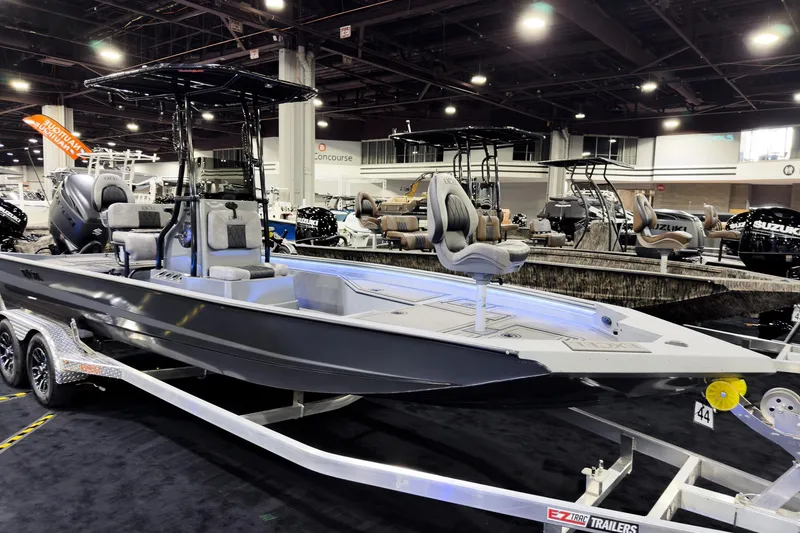 The Image of 2026 Excel 230 Bay Pro Elite boat displayed indoors on a trailer. - 0
