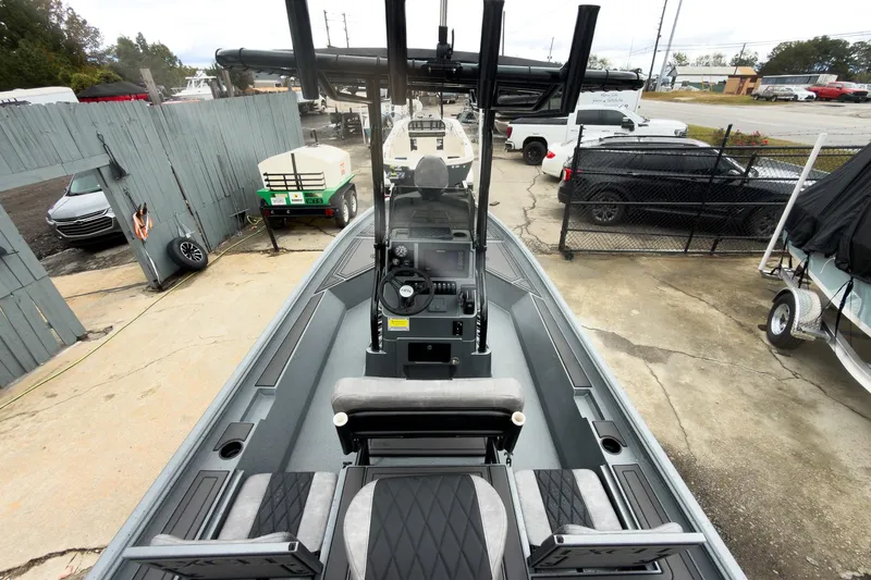 Slide: The Image of 2026 Excel Bay Pro Elite 230 boat, top view, parked in a lot with surrounding vehicles. - 19