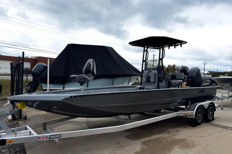 Slide: The Image of 2026 Excel Bay Pro Elite 230 boat on trailer, under cloudy sky. - 34