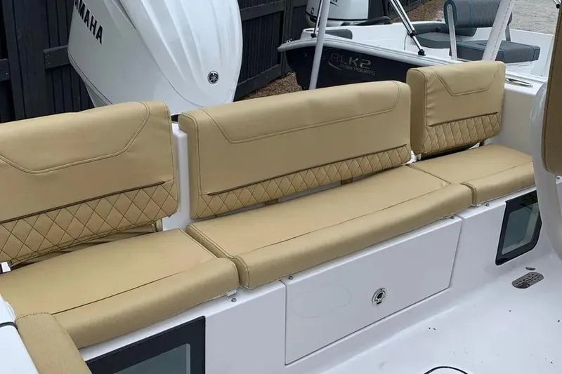 Slide: The Image of 2025 Sportsman Heritage 231 Center Console boat with tan cushioned seating. - 10