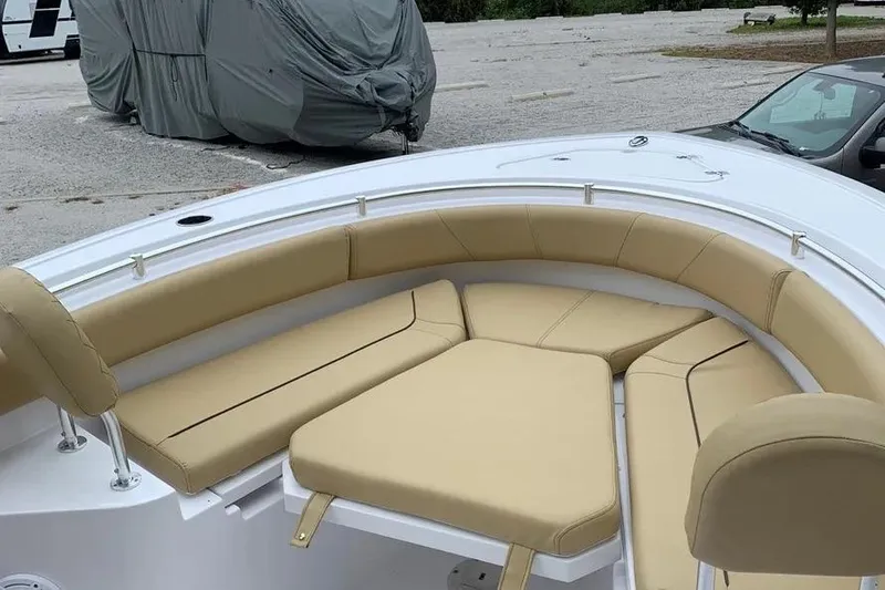 Slide: The Image of 2025 Sportsman Heritage 231 Center Console boat with tan cushioned seating. - 4