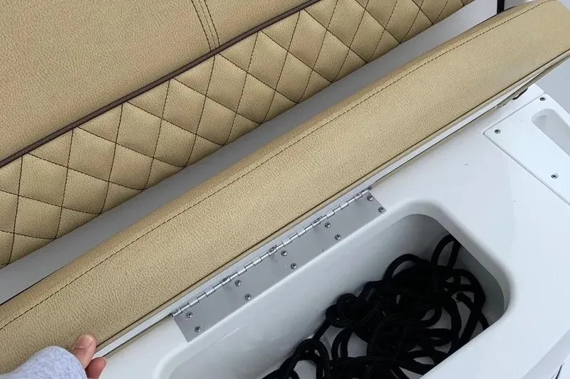 Slide: The Image of 2025 Sportsman Heritage 231 Center Console seat with storage compartment open. - 7