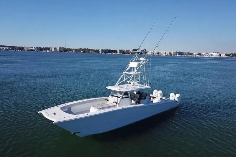 Slide: The Image of 2023 Freeman 47 boat on calm water with cityscape in background. - 11