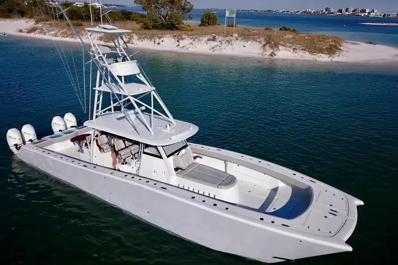 Slide: The Image of 2023 Freeman 47 boat on calm water with cityscape in background. - 2