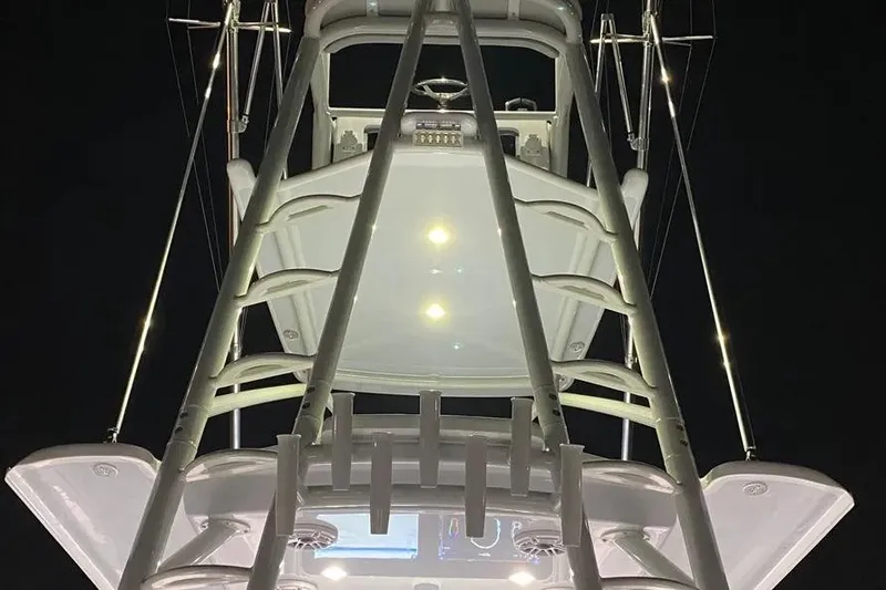 Slide: The Image of 2023 Freeman 47 boat with four engines on calm water. - 5