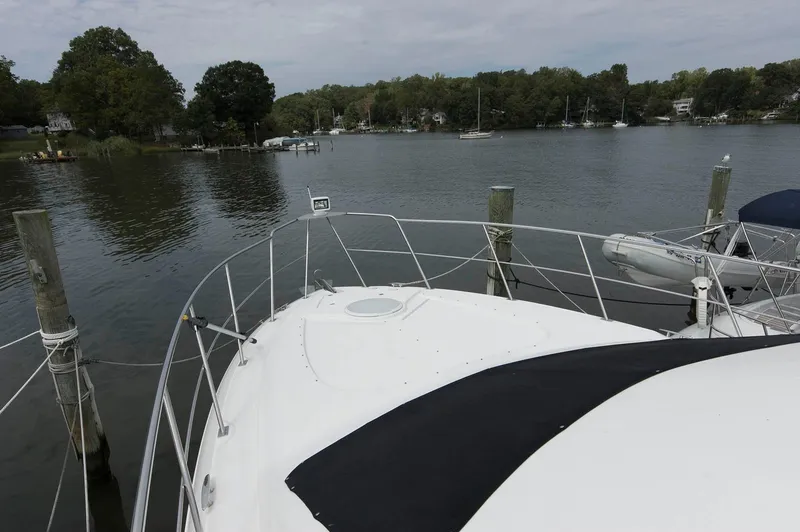 Slide: The Image of 2007 Cruisers Yachts 415 Express Motoryacht at serene lakeside. - 10