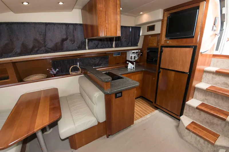 Slide: The Image of Interior of 2007 Cruisers Yachts 415 Express Motoryacht with kitchen and dining area. - 15