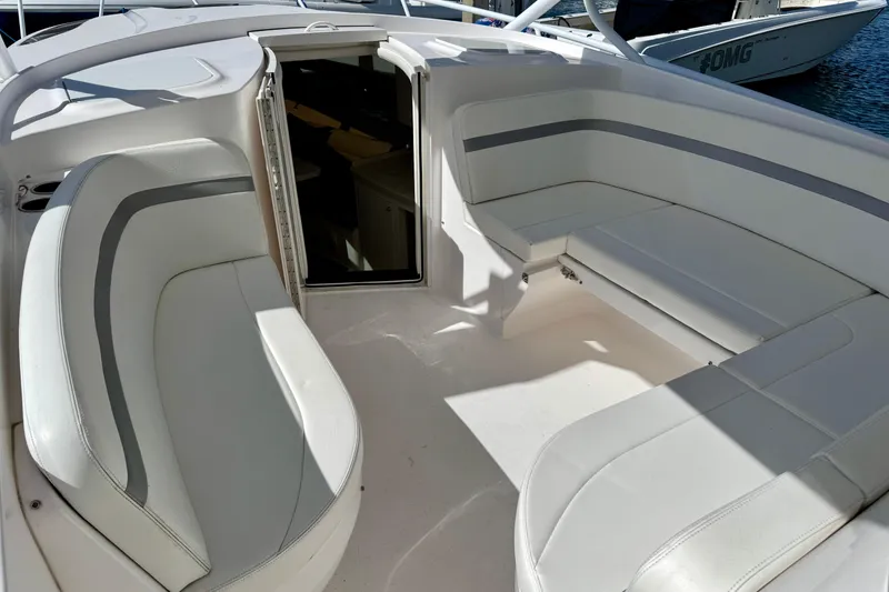 Slide: The Image of 2019 Intrepid 407 Cuddy boat interior with white seating and open cabin door. - 10