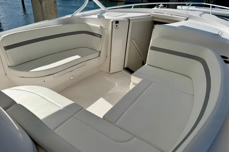 Slide: The Image of 2019 Intrepid 407 Cuddy boat interior with white cushioned seating. - 11