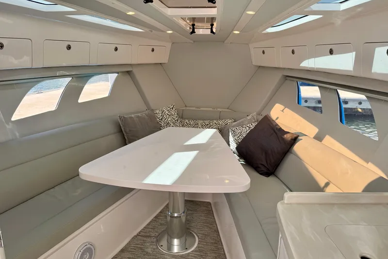 Slide: The Image of Luxurious interior of 2019 Intrepid 407 Cuddy boat with plush seating and elegant table. - 13