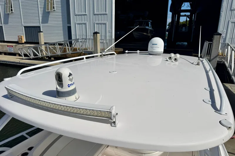 Slide: The Image of 2019 Intrepid 407 Cuddy boat roof with radar and antenna equipment at marina. - 18