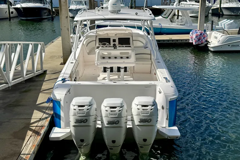 Slide: The Image of 2019 Intrepid 407 Cuddy boat docked, featuring triple 350 horsepower engines. - 3