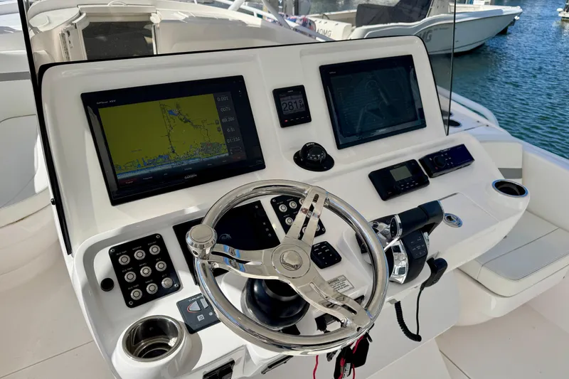 Slide: The Image of Control panel of 2019 Intrepid 407 Cuddy boat with navigation screens and steering wheel. - 4