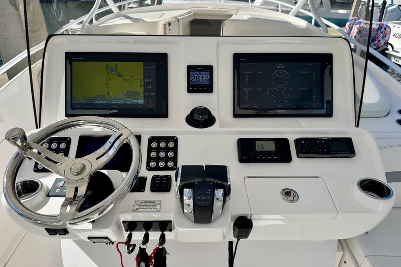 Slide: The Image of Control panel of 2019 Intrepid 407 Cuddy boat with navigation screens and steering wheel. - 7