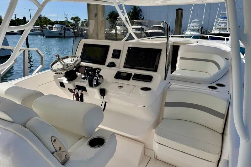 Slide: The Image of 2019 Intrepid 407 Cuddy boat interior with helm, seating, and navigation equipment. - 9