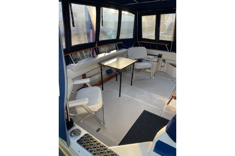 Slide: The Image of Interior of 1983 Bayliner 3270 Explorer with seating and table in enclosed cabin. - 13