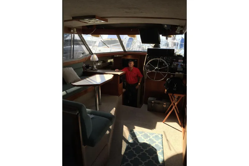 Slide: The Image of Interior of 1983 Bayliner 3270 Explorer yacht with seating and steering wheel. - 15