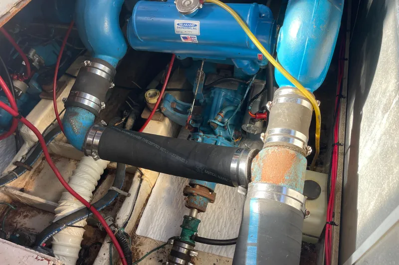 Slide: The Image of Engine compartment of a 1983 Bayliner 3270 Explorer with visible hoses and components. - 17