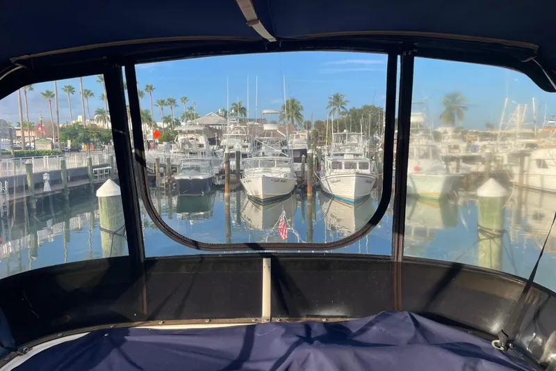 Slide: The Image of View from 1983 Bayliner 3270 Explorer, overlooking marina with boats and palm trees. - 9