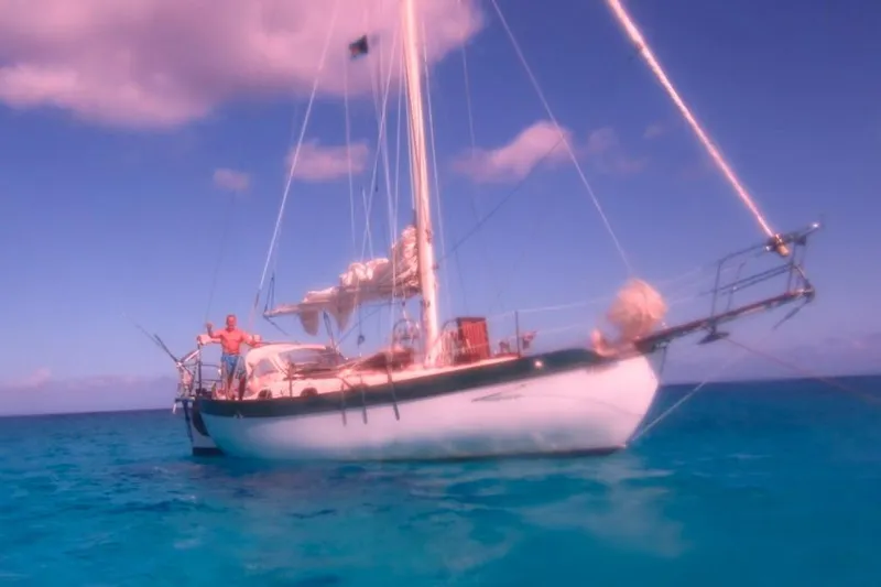 The Image of 1977 Westsail Cutter sailboat on clear blue ocean under a vibrant sky. - 1