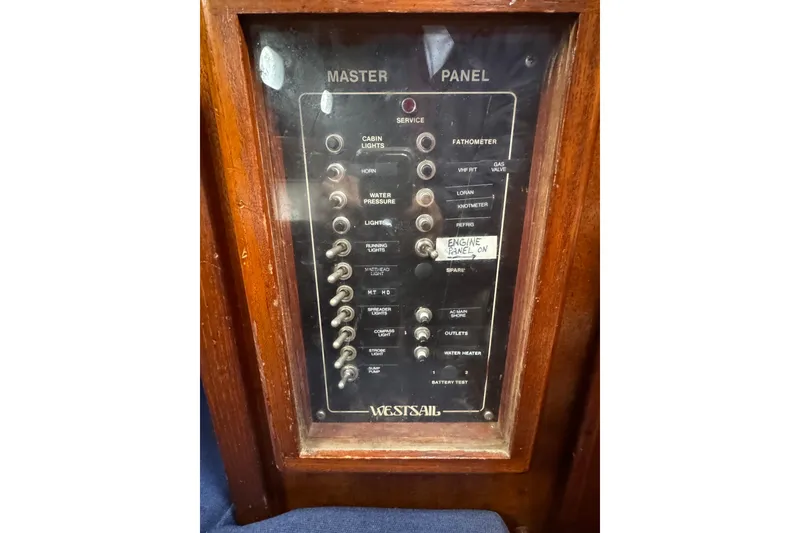 Slide: The Image of 1977 Westsail Cutter master panel with switches for cabin lights, water pressure, and more. - 14