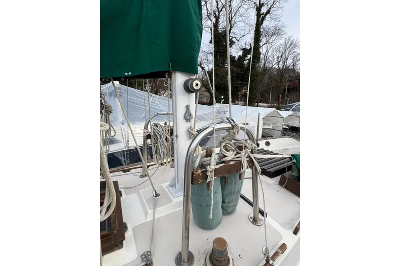 Slide: The Image of 1977 Westsail Cutter sailboat deck with ropes and green canopy. - 37