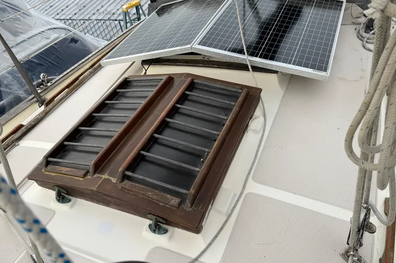 Slide: The Image of 1977 Westsail Cutter deck with solar panels and wooden hatch. - 41
