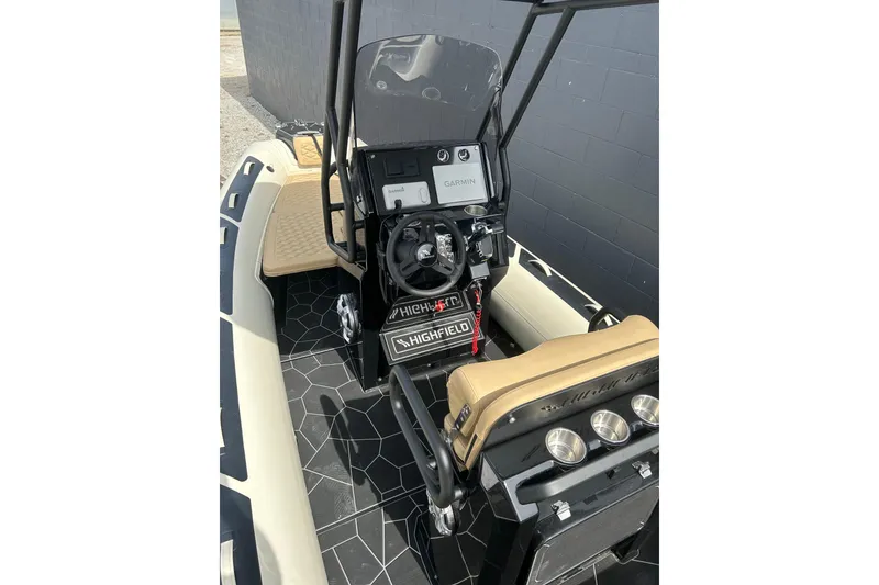 Slide: The Image of 2024 Highfield Sport 560 boat interior with steering console and seating. - 12