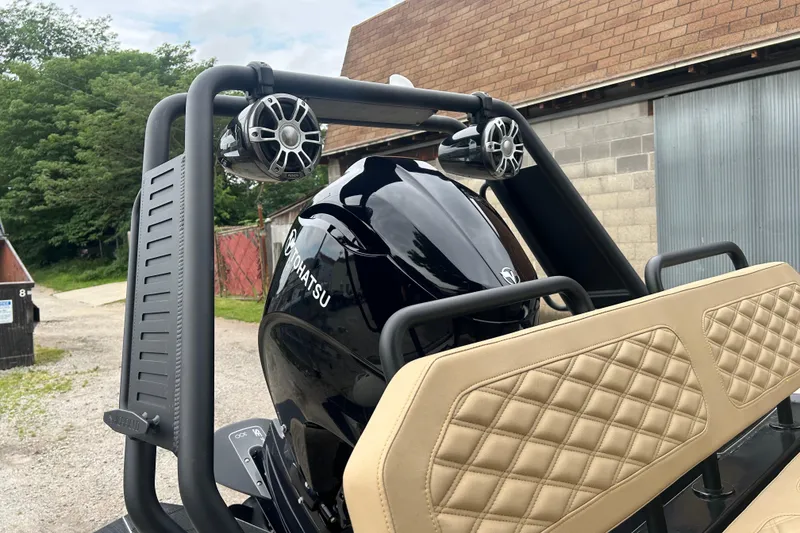 Slide: The Image of 2024 Highfield Sport 560 boat with Tohatsu engine and beige quilted seats. - 2