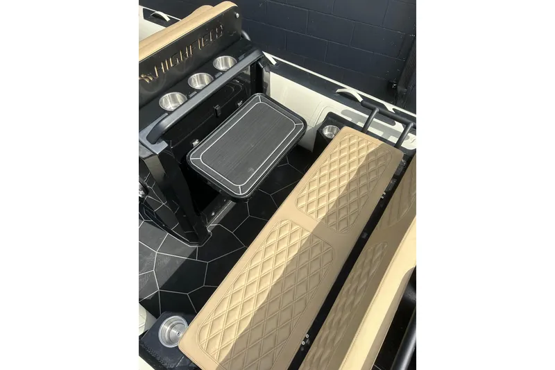 Slide: The Image of 2024 Highfield Sport 560 boat interior with tan quilted seats and cup holders. - 7