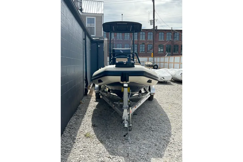 Slide: The Image of 2024 Highfield Sport 560 boat on trailer in urban setting. - 9