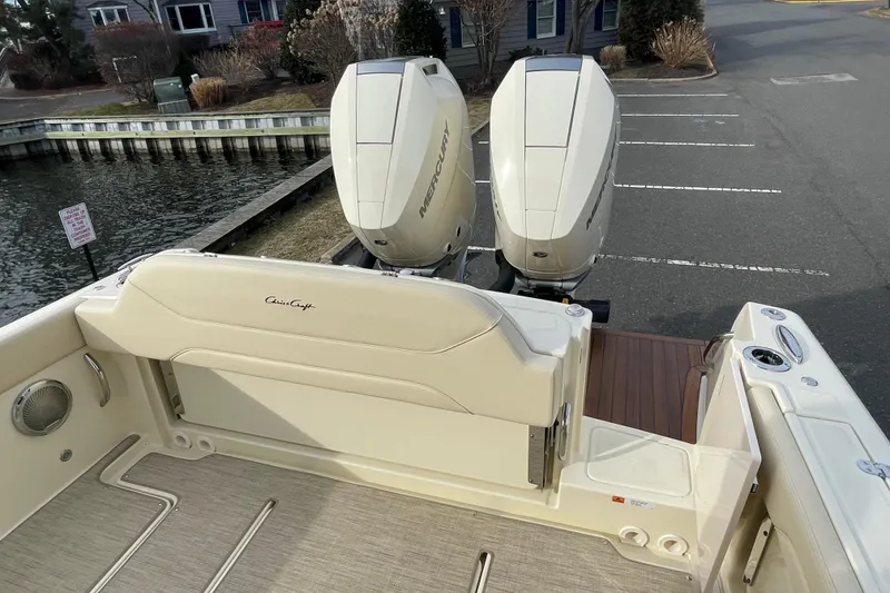 Slide: The Image of 2026 Chris-Craft 310 Catalina boat with dual Mercury outboard engines docked by the water. - 15