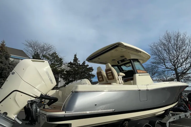 Slide: The Image of 2026 Chris-Craft 310 Catalina boat with Mercury engine, parked outdoors. - 2
