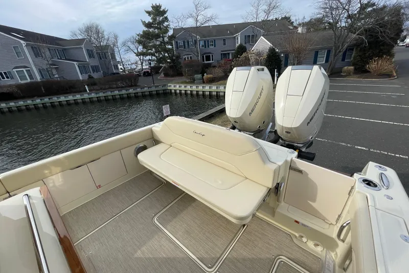 Slide: The Image of 2026 Chris-Craft 310 Catalina boat with dual Mercury engines docked near waterfront homes. - 21