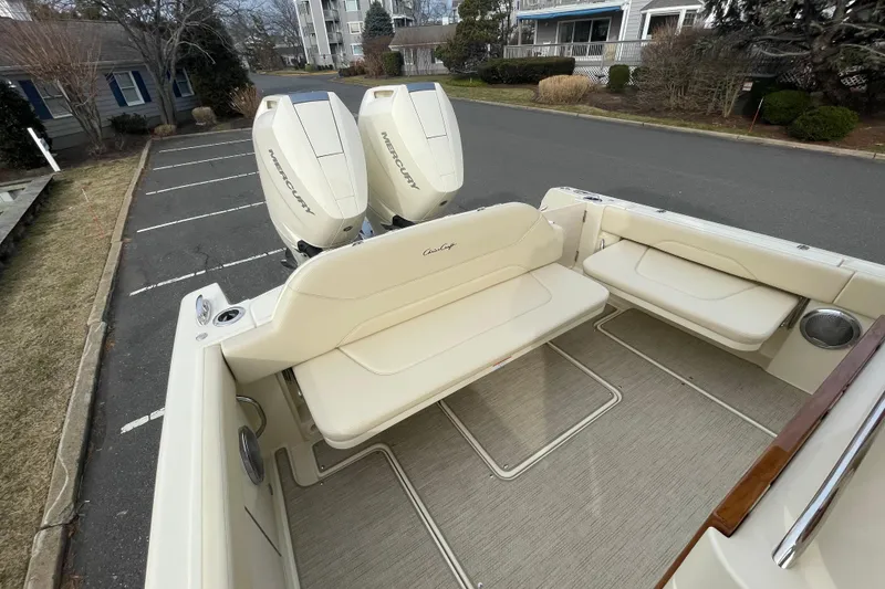 Slide: The Image of 2026 Chris-Craft 310 Catalina boat with Mercury engines, beige seating, and spacious deck. - 23