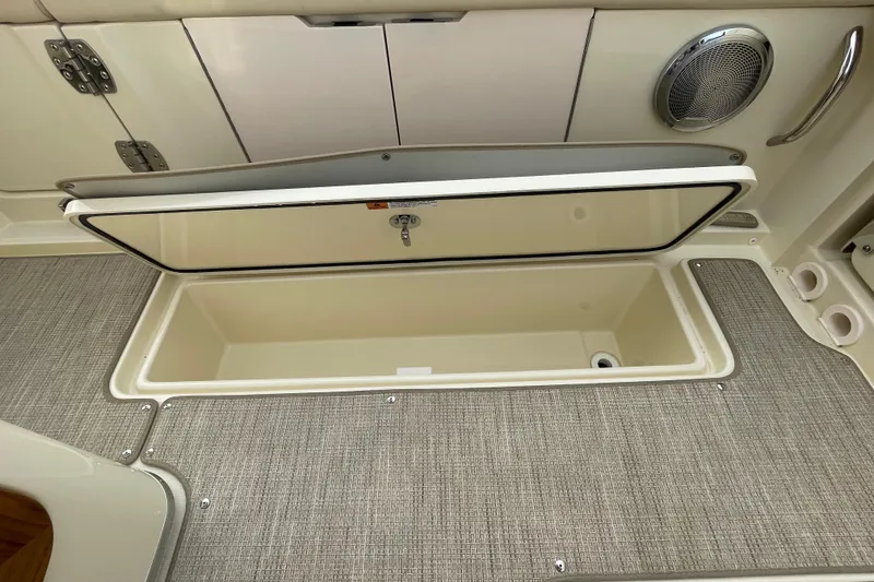 Slide: The Image of 2026 Chris-Craft 310 Catalina storage compartment with open lid, showcasing spacious interior. - 27
