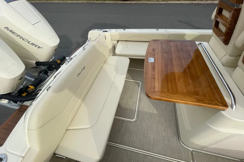 Slide: The Image of 2026 Chris-Craft 310 Catalina boat interior with seating and wooden table. - 30